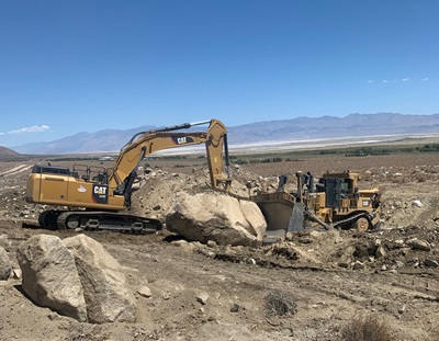 bulldozer pushing rock