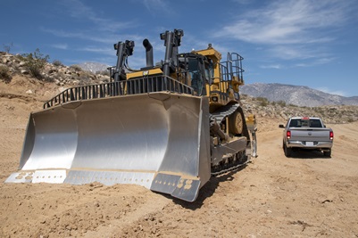 a pickup truck next to a bulldozer