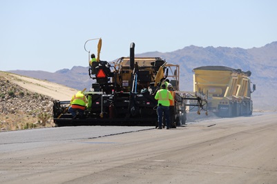 Paving crews lay asphalt on the Olancha Cartago Project.